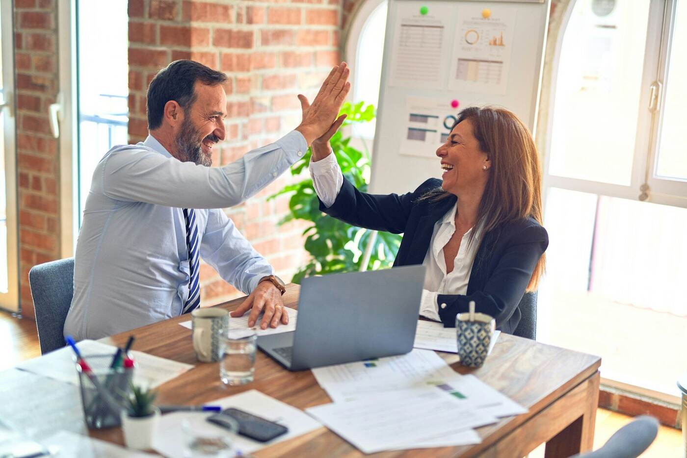 A professional property manager discussing rental management details with a property owner at a modern office.