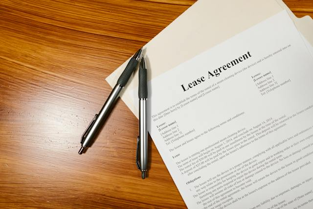A lease agreement document with a pen on a desk.