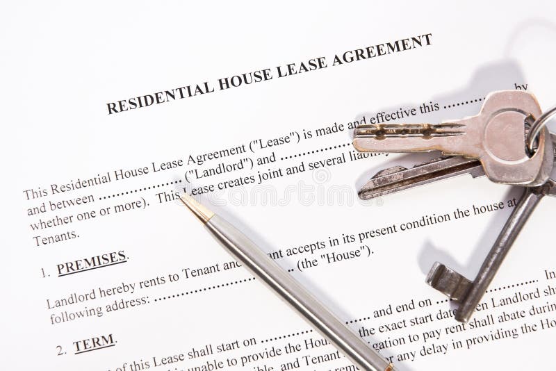 Tenant and landlord reviewing and signing a lease renewal agreement at a table.