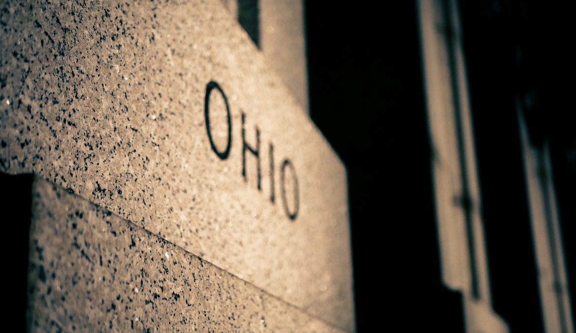 Ohio rental lease agreement document on a desk, representing landlord-tenant rights and rental law overview.